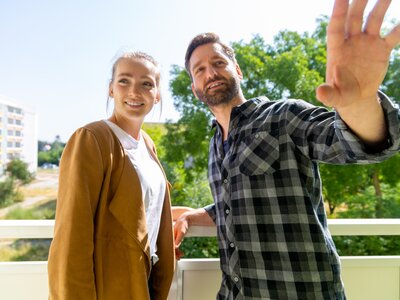 Pärchen auf dem Balkon ihrer Wohnung
